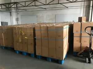 Fokis customized adhesives packed in cartons, neatly arranged on blue shipping pallets, ready for dispatch.