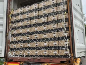 Front view of Fokis' customized spray adhesives neatly loaded on a truck, secured with white netting straps, reflecting the company's attention to detail in handling shipments.