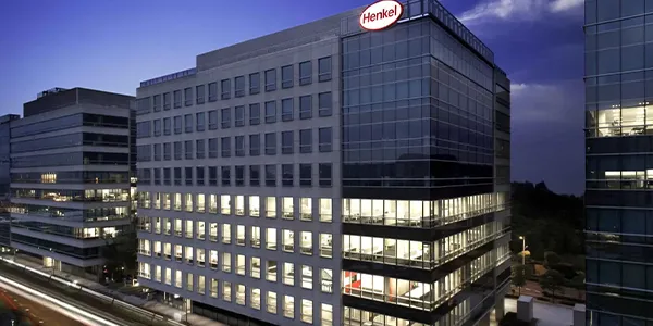 Henkel China Group corporate building at dusk, with the interior brightly lit.